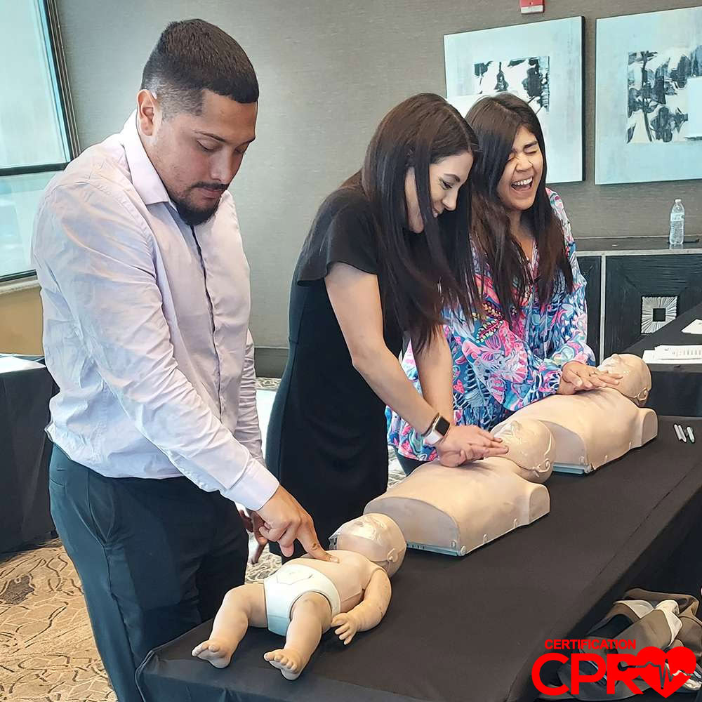 CPR training class in West Palm Beach with students practicing on mannequins.